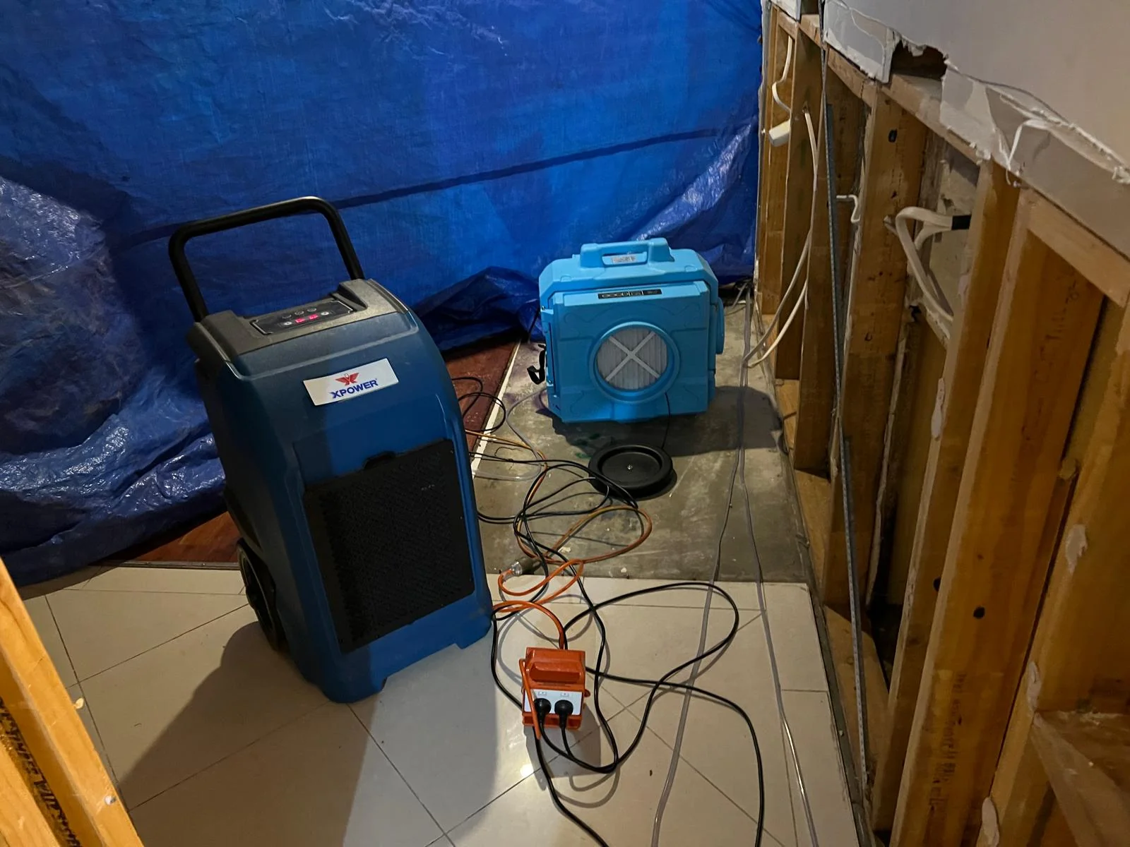 Water extraction equipment being used on a wet floor